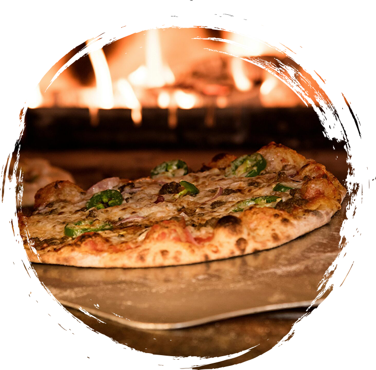 A pizza sitting in front of a fireplace.