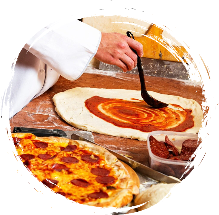 A chef is slicing a pepperoni pizza.