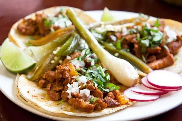 A plate of tacos on a white plate.